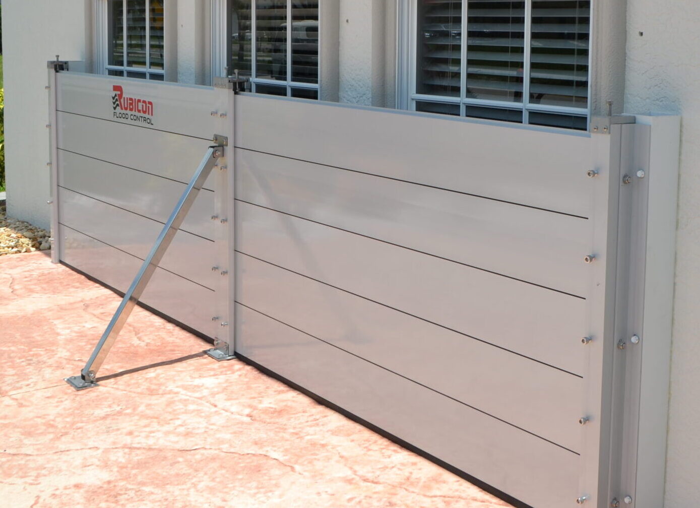 BarrierX modular aluminum flood barrier protecting a patio window line