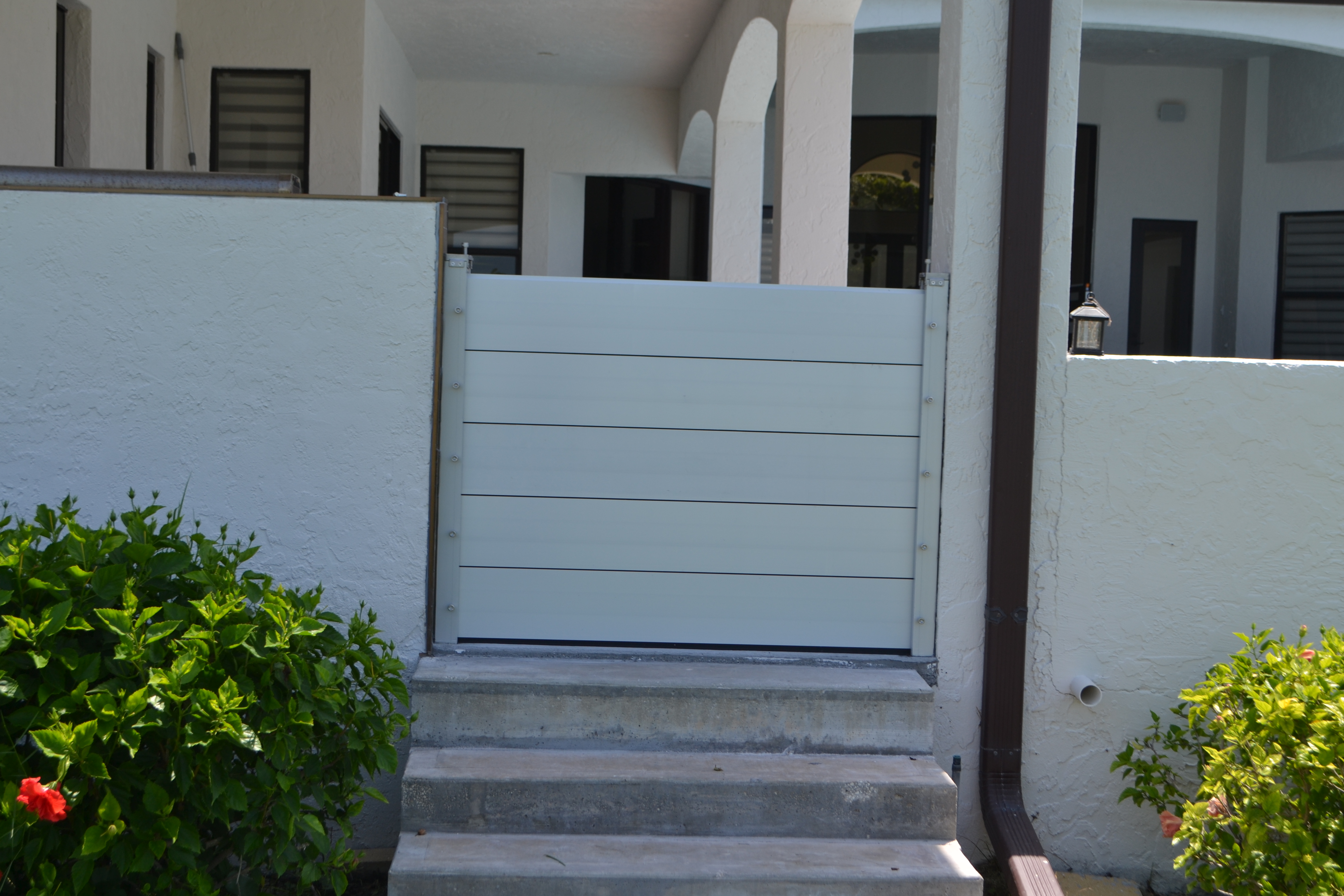 Rubicon deployable aluminum flood panels installed across a Florida home opening